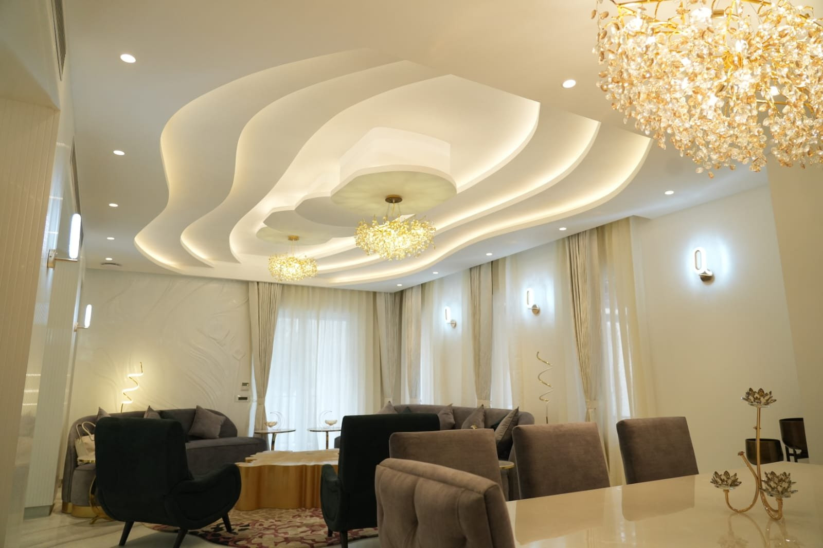 A curved corridor at Malhan Mansion, with brass ring pendants following the turn of the wall