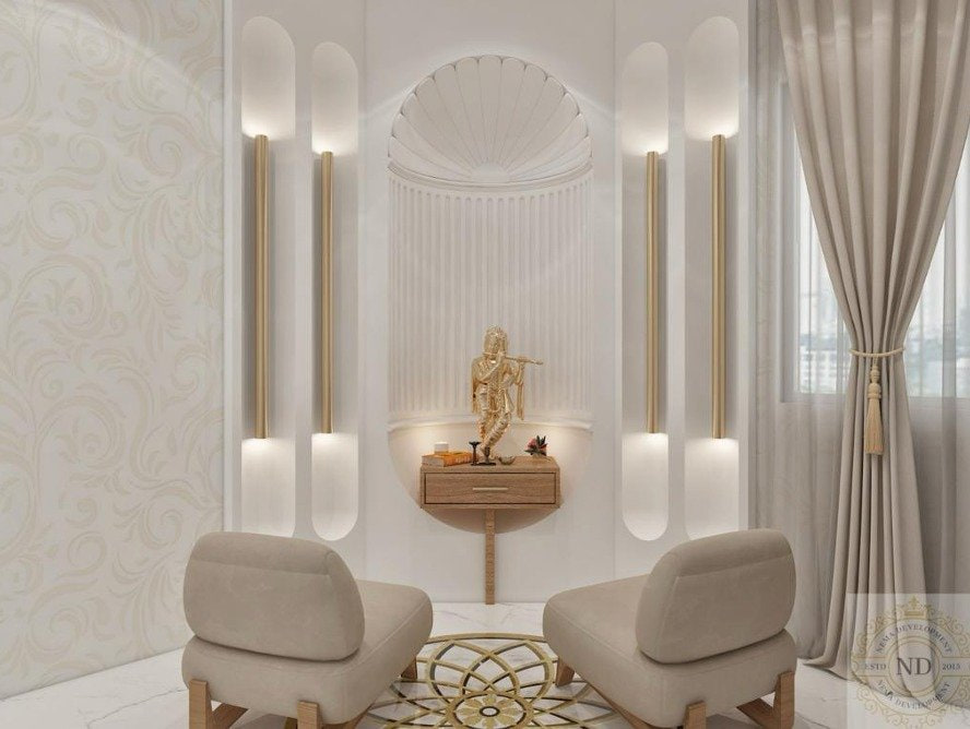 Paras Quartier 501, Paras Quartier, Gurugram — An arrival room. Fluted white columns, a pair of low chairs, and a lit niche holding a single bronze figure — the room is a frame for one object.